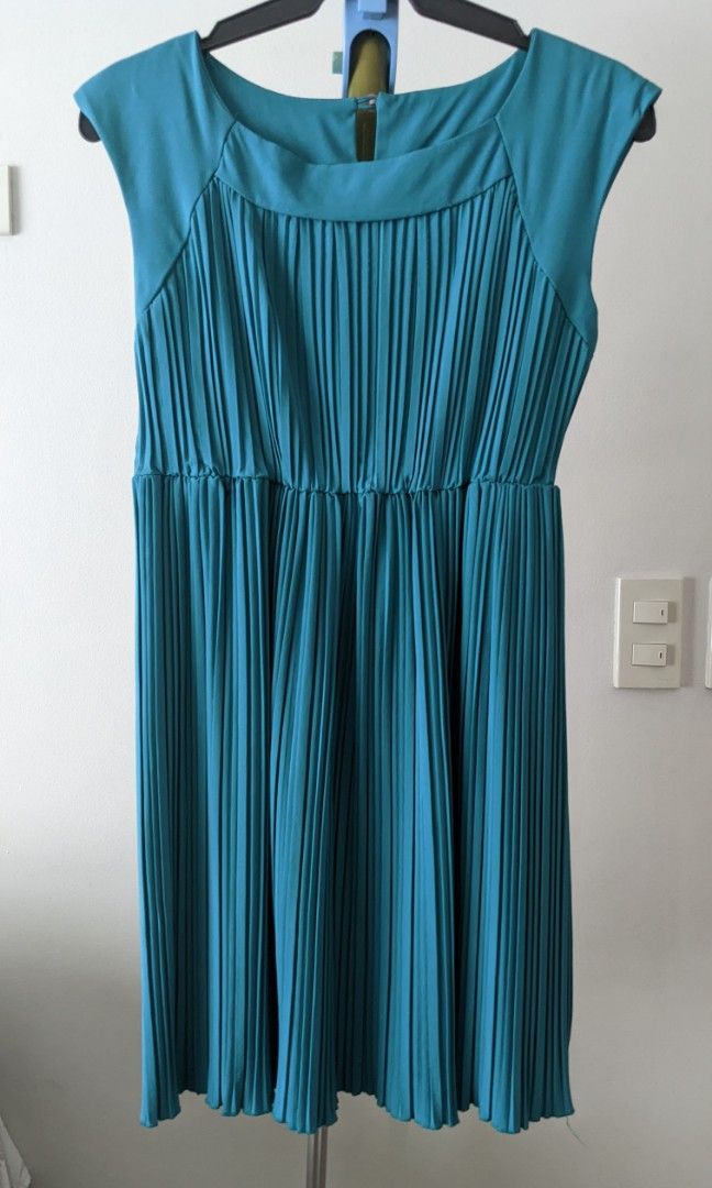 Teal pleated mini-dress (Category: Dresses) located in Mandaluyong City. Submitted by clf97 (Listing ID 1310146275, Image 1). Description: Short pleated sleeveless dress with retro feels in bright teal 🩵 Gartered waist. Wide collar with button fastening at the back. Sits approximately 2 inches above the knee..