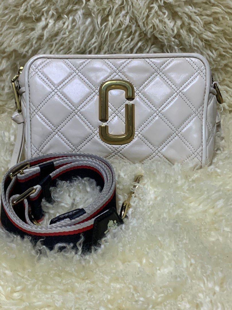 Authentic Marc Jacobs Quilted Soft Shot 21 (Category: Luxury Bags & Wallets) located in Rosario. Submitted by myvinatgepieces (Listing ID 1310549563, Image 2). Description: Authentic Marc Jacobs Soft shot 21 Ivory Color An oversized double-J logo gleams from a supple, quilted leather bag you can carry as a clutch or sling over your shoulder with the optional strap. Quilted Lambskin Leather Replaced Original MJ Guitar Strap Minimal Color Transfer 