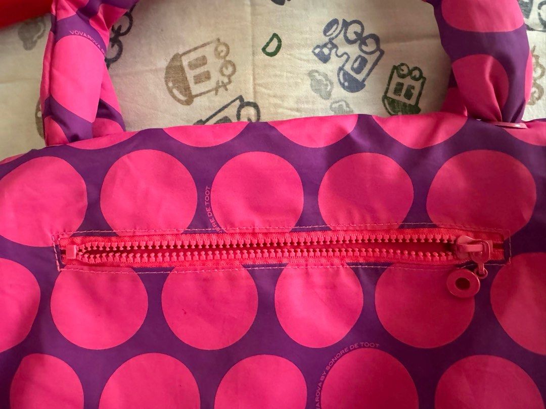 Authentic Vovarova Duffel Bag (Category: Tote Bags) located in Manila. Submitted by etcetera.mnl (Listing ID 1310712781, Image 2). Description: Authentic Vovarova Duffel Bag Like New Condition Unused/Bought and Stored Striking Colors of Magenta & Fuchsia Nylon Material; Water-repellent Soft and fluffy (fiberfill) 1 interior and 1 exterior pocket Dimension 16 x 14 x 12 inches Bought for 3k Selling for 1,500 only Items we sell are personally bought