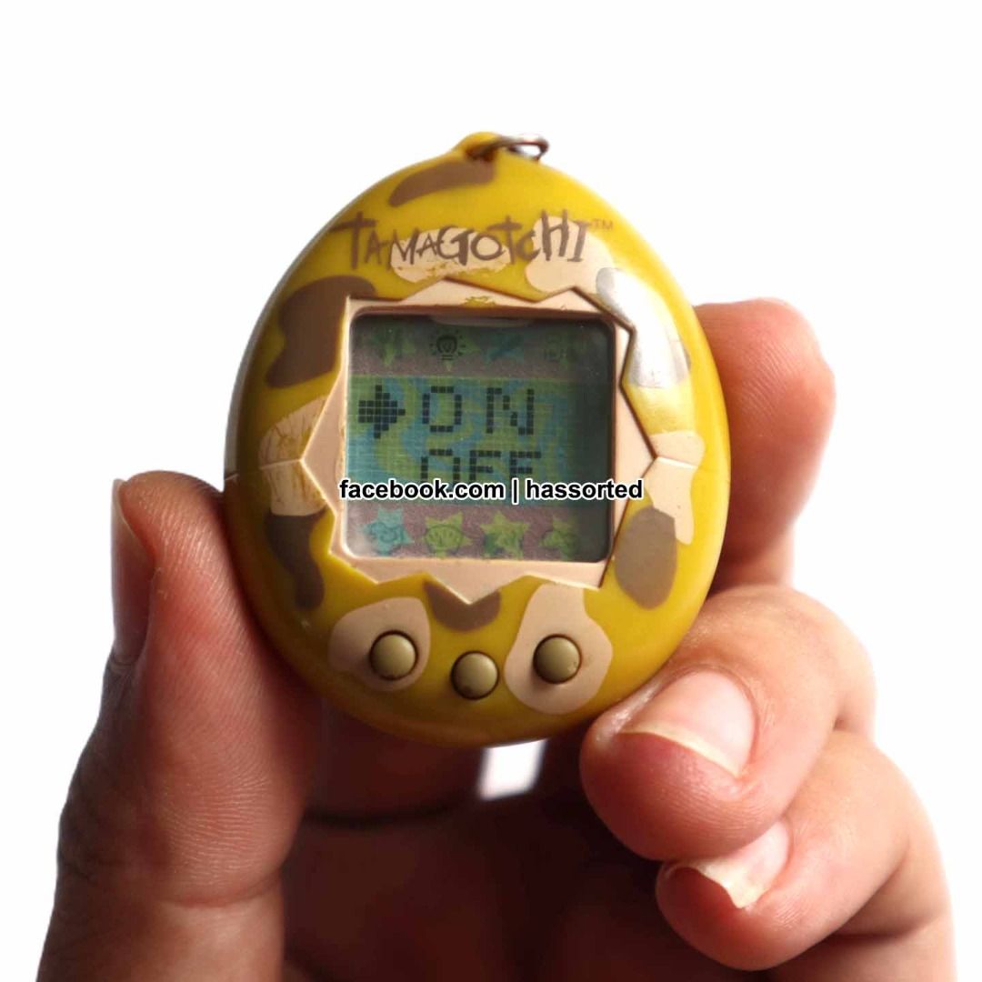tamagotchi (Category: Interactive Toys) located in Makati City. Submitted by hassorted09 (Listing ID 1304528163, Image 3). Description: (wysiswyg) brick game - 250 l-blue / lost contact on screen tamagotchi - 800 tan camouflage / working / english can be attached to any current charms/keychains :) vintage, from 90's so cute to collect or use scratch/paintchips whatyouseeiswhatyouget.