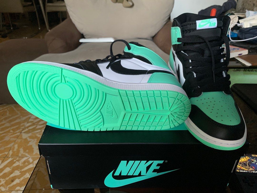 Jordan 1 retro High OG (Category: Sneakers) located in Marikina City. Submitted by chestmaester708 (Listing ID 1311257991, Image 2). Description: The shoe in the image is a Nike Air Jordan 1 High OG. It features a striking colorway with mint green, black, and white. The upper part of the shoe has a combination of mint green leather on the toe box and heel, black overlays on the toe cap, lace guard, and ankle collar, with white side panels. The bl