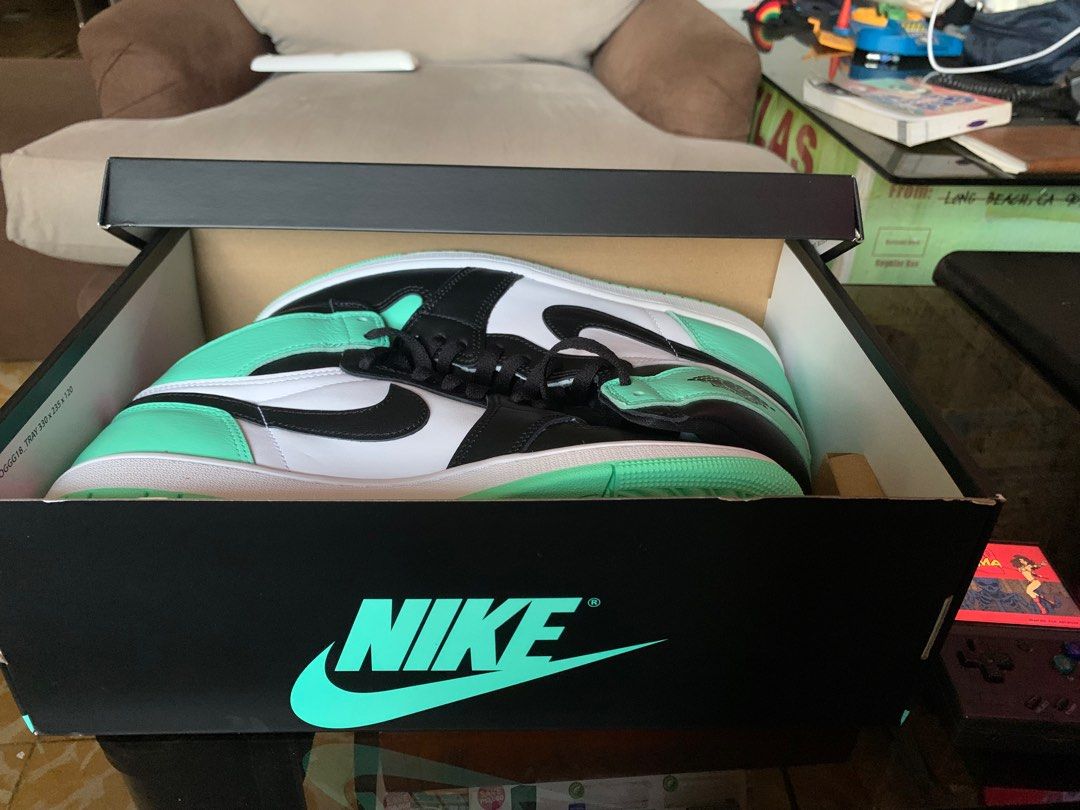 Jordan 1 retro High OG (Category: Sneakers) located in Marikina City. Submitted by chestmaester708 (Listing ID 1311257991, Image 3). Description: The shoe in the image is a Nike Air Jordan 1 High OG. It features a striking colorway with mint green, black, and white. The upper part of the shoe has a combination of mint green leather on the toe box and heel, black overlays on the toe cap, lace guard, and ankle collar, with white side panels. The bl
