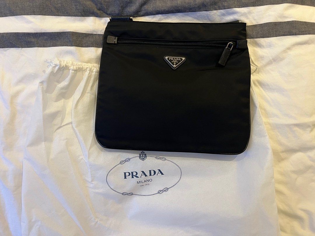 Prada sling/messenger bag (authentic) (Category: Luxury Bags & Wallets) located in Makati City. Submitted by marckyboy (Listing ID 1311507942, Image 1). Description: - Authentic Prada Bandoliera messenger bag - Black nylon exterior - Front zip pocket - Main compartment - Prada triangle logo - Includes authenticity cards - Adjustable shoulder strap - With NFC - Bought in Paris, France - With e-receipt/hardcopy - Complete inclusions authenticity ca