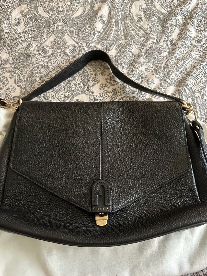 Authentic Furla Black Leather Bag (Category: Luxury Bags & Wallets) located in Mandaluyong City. Submitted by hdvvv (Listing ID 1311536814, Image 1). Description: Black leather bag from Furla Bought in Paris for Eur 600 Really really good quality bag. Long and short shoulder strap. Functional and chic. Inclusions - dustbag and strap Meetup encouraged so you can check the quality and beauty of the bag Rfs: Funding a new bag.