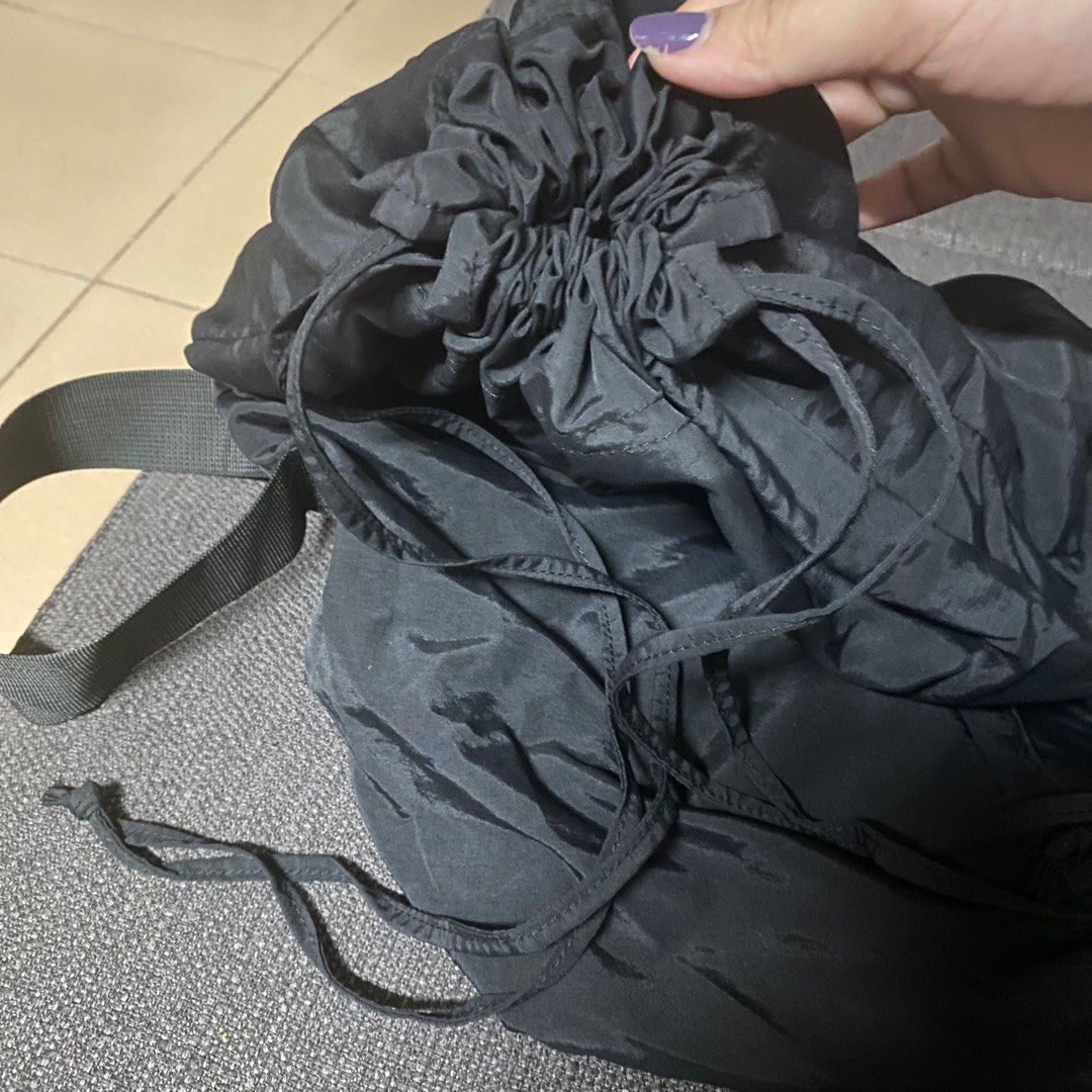 Black drawstring tote bag (Category: Tote Bags) located in Manila. Submitted by ranze (Listing ID 1311660187, Image 2). Description: Good to match with street wear outfits. Bought it on tiktok shop. .