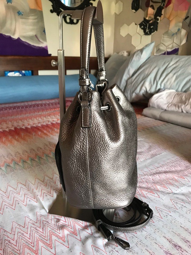 Oryany bucket bag with sling (Category: Luxury Bags & Wallets) located in Santa Rosa. Submitted by rina.rina3 (Listing ID 1311540811, Image 3). Description: Silvery gold Oryany bucket bag with detachable sling Preowned from Korea Gunmetal excellent hardwares Very soft but thick leather With minimal unnoticeable flaw - scrape in front hence selling low (see last picture) Bag dimensions LXWXH 7.5in x 5in x 9in Bag height including top handle is 13.