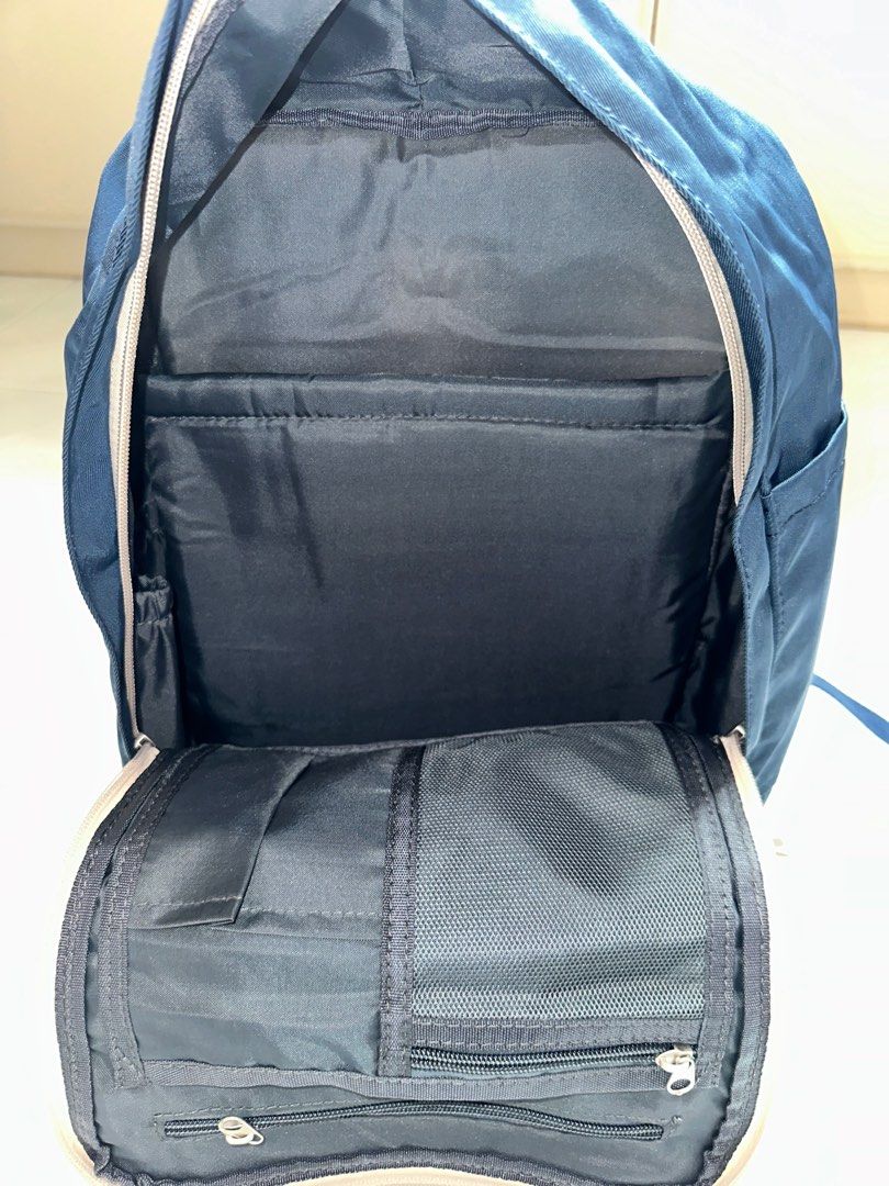 Backpack (Category: Backpacks) located in Singapore. Submitted by bunnytoothx (Listing ID 1306901065, Image 3). Description: Brand new without tag. Comfortably fits 13" laptop. Multiple inner pockets and zips as shown in the photos. Has 2 inner side pockets for umbrella/water bottle. Very functional bag. Selling as underutilised. .