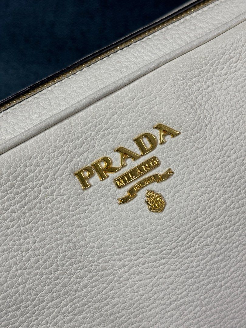 Prada Double Zip Camera Bag in White (Category: Luxury Bags & Wallets) located in San Fernando. Submitted by olliebash (Listing ID 1307194169, Image 2). Description: Purchased in California last 2018 as my first ever luxury bag. Condition: 9/10 Issues: Very minimal signs of usage and strap discoloration RFS: Not in use and will upgrade Comes with dust bag and authentication cards Message me for more detailed photos! Zara mango uniqlo bershka h&m 