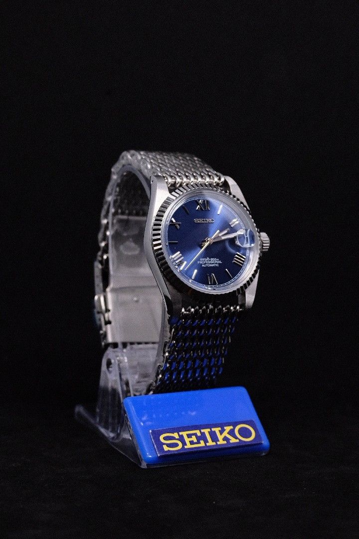 Seiko Mod Datejust Blue Roman (Category: Luxury Watches) located in Manila. Submitted by rafael_lesaguis (Listing ID 1307116826, Image 2). Description: BRANDNEW (Never-yet-worn) Model: Seiko Mod Datejust Blue Roman Movement: Seiko NH35 Automatic TMI version with winding and hacking feature Case and Strap: 39mm 904L Stainless Steel / Mesh Strap Dial: Seiko logo, Blue Sunburst Roman Numeral Dial Glass: Sapphire scratch resistant with cyclops Hands: