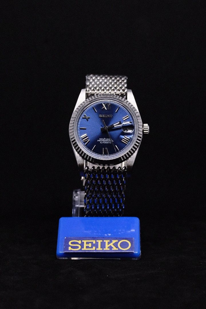 Seiko Mod Datejust Blue Roman (Category: Luxury Watches) located in Manila. Submitted by rafael_lesaguis (Listing ID 1307116826, Image 1). Description: BRANDNEW (Never-yet-worn) Model: Seiko Mod Datejust Blue Roman Movement: Seiko NH35 Automatic TMI version with winding and hacking feature Case and Strap: 39mm 904L Stainless Steel / Mesh Strap Dial: Seiko logo, Blue Sunburst Roman Numeral Dial Glass: Sapphire scratch resistant with cyclops Hands:
