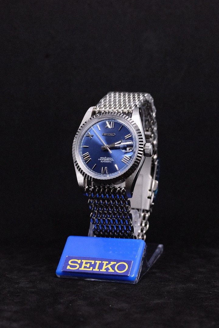 Seiko Mod Datejust Blue Roman (Category: Luxury Watches) located in Manila. Submitted by rafael_lesaguis (Listing ID 1307116826, Image 3). Description: BRANDNEW (Never-yet-worn) Model: Seiko Mod Datejust Blue Roman Movement: Seiko NH35 Automatic TMI version with winding and hacking feature Case and Strap: 39mm 904L Stainless Steel / Mesh Strap Dial: Seiko logo, Blue Sunburst Roman Numeral Dial Glass: Sapphire scratch resistant with cyclops Hands: