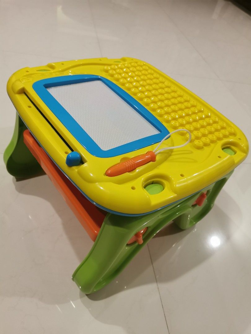 Activity Table (Category: Infant Playtime) located in Singapore. Submitted by tommolee (Listing ID 1307375677, Image 4). Description: Infant playtable.... Has building blocks, magnetic writing pad, rattlers, etc. Good for building hand eye coordination..