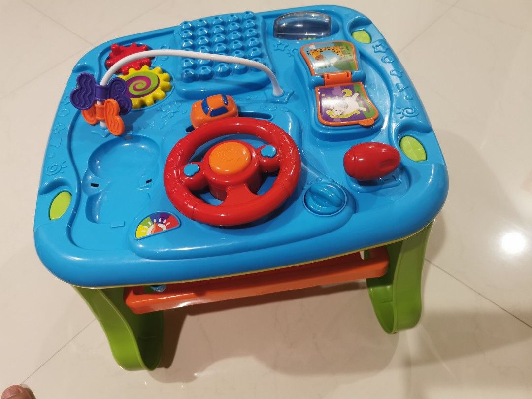 Activity Table (Category: Infant Playtime) located in Singapore. Submitted by tommolee (Listing ID 1307375677, Image 1). Description: Infant playtable.... Has building blocks, magnetic writing pad, rattlers, etc. Good for building hand eye coordination..