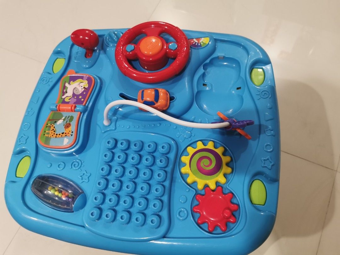 Activity Table (Category: Infant Playtime) located in Singapore. Submitted by tommolee (Listing ID 1307375677, Image 3). Description: Infant playtable.... Has building blocks, magnetic writing pad, rattlers, etc. Good for building hand eye coordination..