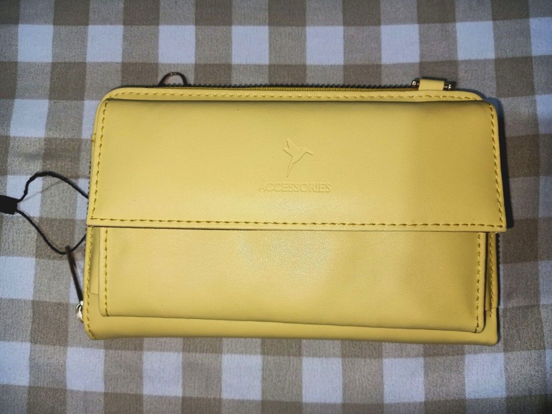 Sling Wallet / Phone Sling (Category: Wallets & Card holders) located in Angeles City. Submitted by ejhere (Listing ID 1307643742, Image 1). Description: 📌Kindly read the below details before you make an inquiry or offer.😊 ITEM: Sling Wallet / Phone Sling BRAND: Accessories CONDITION: Excellent condition, like new COLOR: Yellow SIZE: 7" X 4.5" OTHER REMARKS: No flaws, Missing Chain Strap; can fit 6"phone 🔻MOP: GCASH 🔻COURIER: J&T 🔻SHIPPING F
