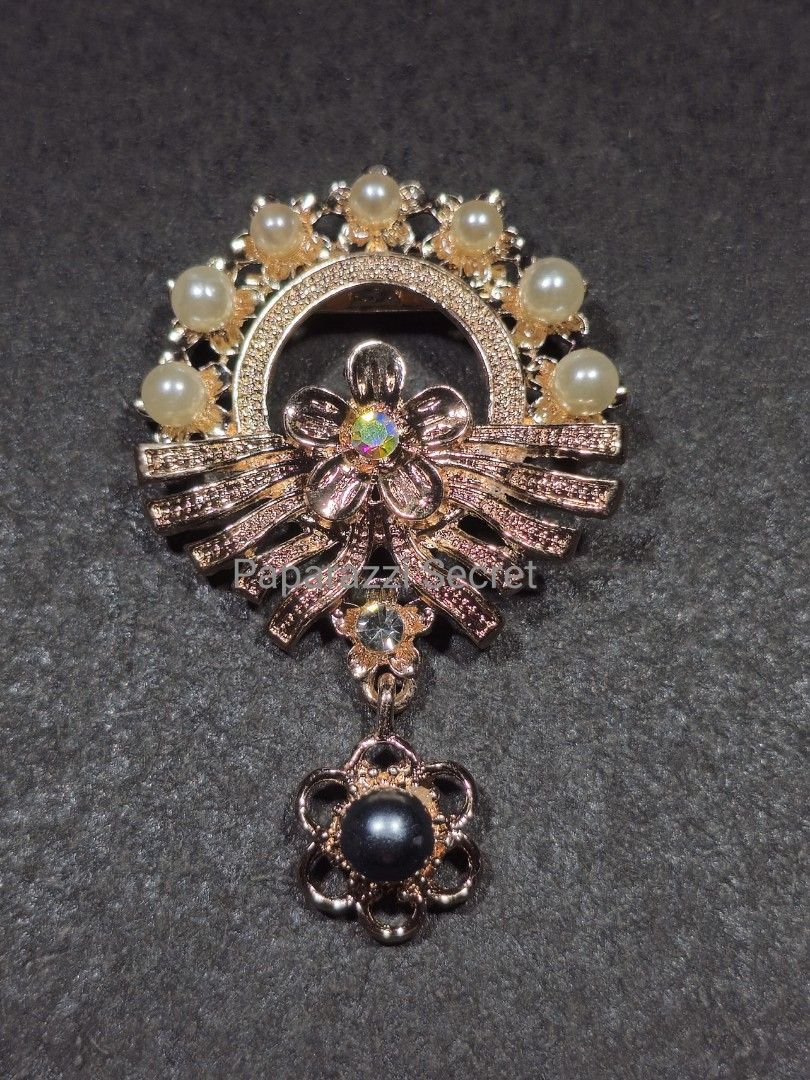 Brooch in malay top