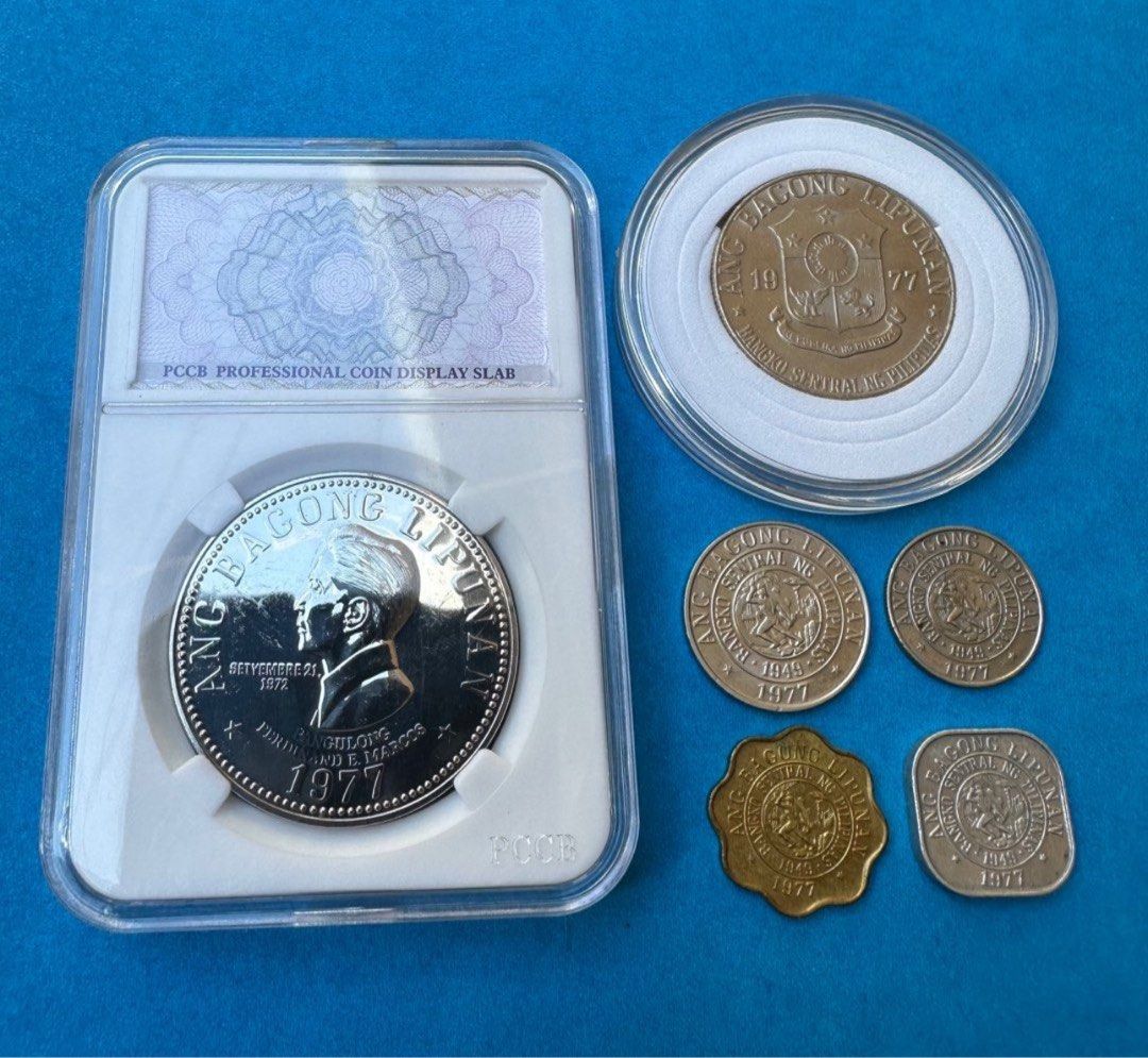 1977 Marcos coin sets (Category: Currency) located in Manila. Submitted by edwinmejoradapnp (Listing ID 1313509374, Image 1). Description: In 1977, Ferdinand Marcos coins were part of the Ang Bagong Lipunan series, which included the circulating five-peso coin featuring Marcos' profile on the obverse and the coat of arms on the reverse..