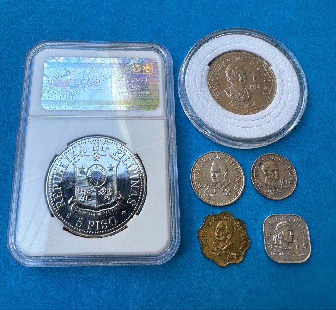1977 Marcos coin sets (Category: Currency) located in Manila. Submitted by edwinmejoradapnp (Listing ID 1313509374, Image 2). Description: In 1977, Ferdinand Marcos coins were part of the Ang Bagong Lipunan series, which included the circulating five-peso coin featuring Marcos' profile on the obverse and the coat of arms on the reverse..