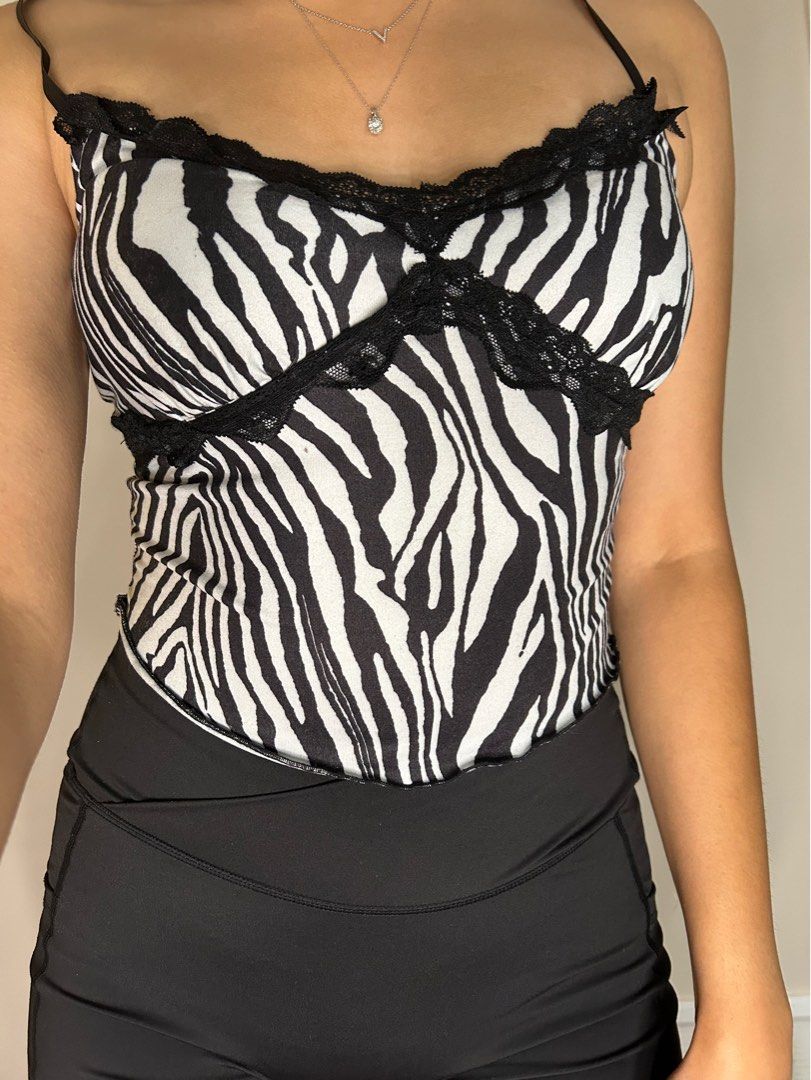Fun Zebra Print Lacey Accent Thin Strap Crop Top (Category: Clothes) located in Toronto. Submitted by venya260 (Listing ID 1313457167, Image 1). Description: Brand: Shien Size: US S Colour: Black and White Clothing Blend: 92% Polyester & 8% Spandex Condition: Used .