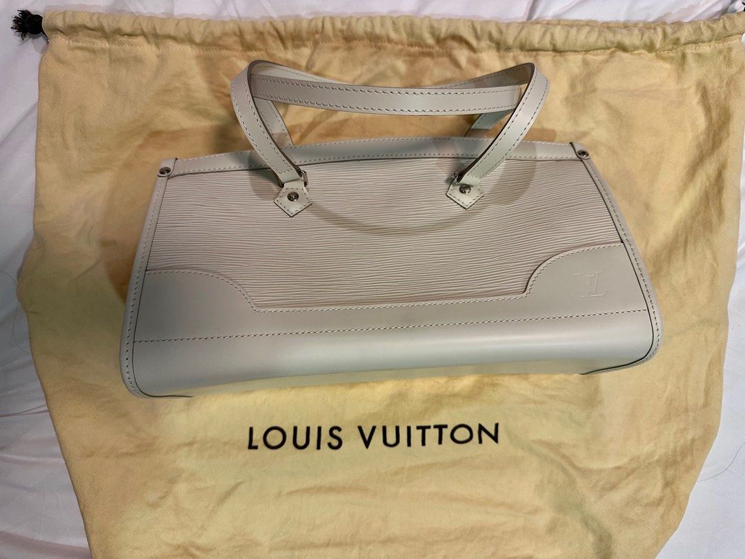 Louis Vuitton Madeleine PM Ivory (Category: Luxury Bags & Wallets) located in Quezon City. Submitted by missmari (Listing ID 1313735159, Image 3). Description: This classy Louis Vuitton Madeleine PM Ivory tote is finely crafted of LV’s signature textured epi leather in white. The tote features smooth white leather trim and double top handles, with polished silver hardware. The top zipper opens to an ivory fabric interior with a patch pocket. This