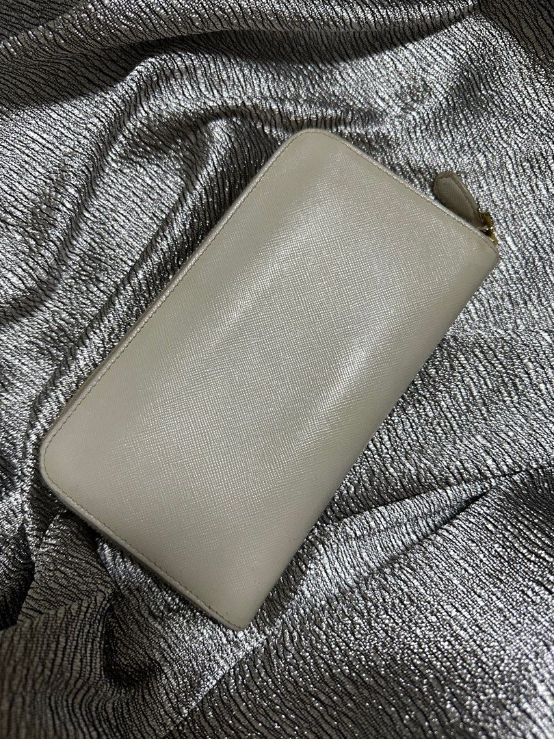 AUTHENTIC Prada Off White Wallet (Category: Luxury Bags & Wallets) located in Quezon City. Submitted by FashionFab (Listing ID 1314121659, Image 3). Description: 100% orig. Used twice. Prada Long wallet leather. In a very good condition..