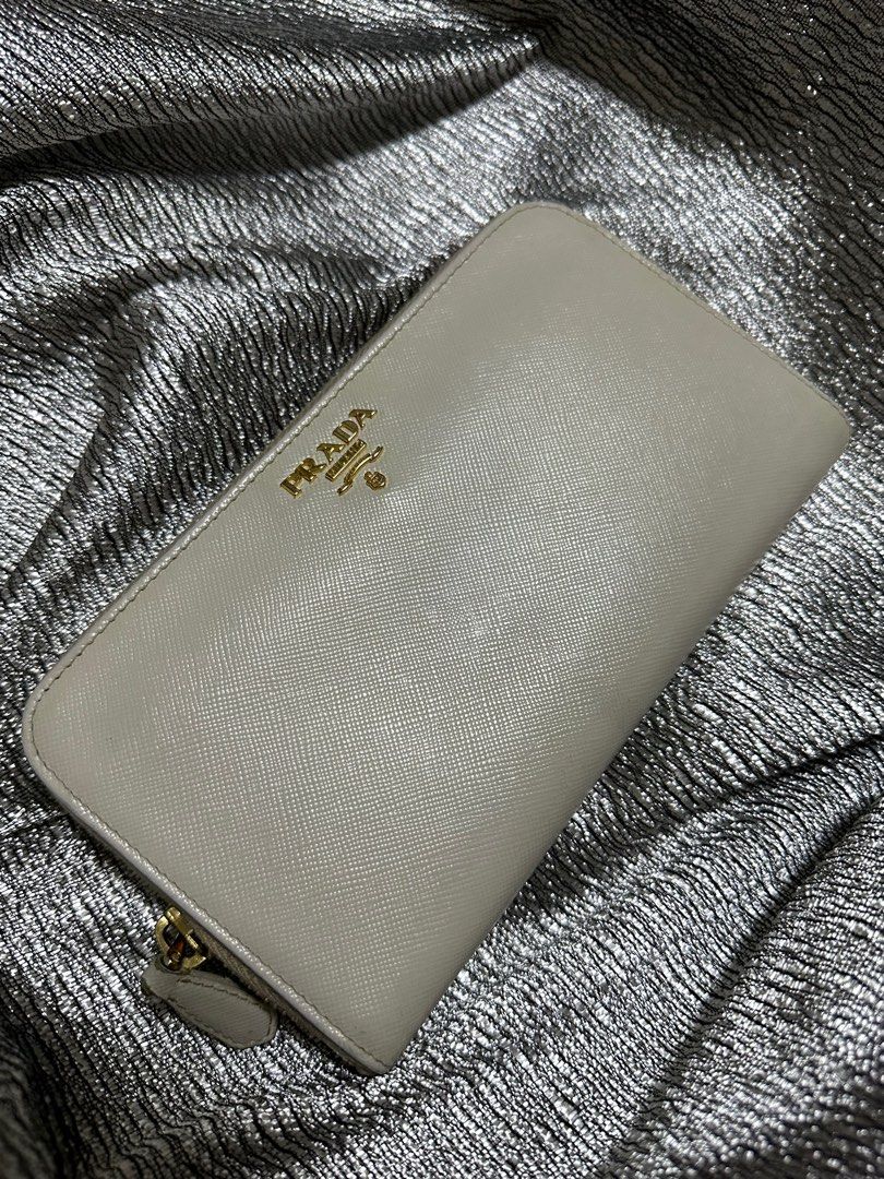 AUTHENTIC Prada Off White Wallet (Category: Luxury Bags & Wallets) located in Quezon City. Submitted by FashionFab (Listing ID 1314121659, Image 1). Description: 100% orig. Used twice. Prada Long wallet leather. In a very good condition..