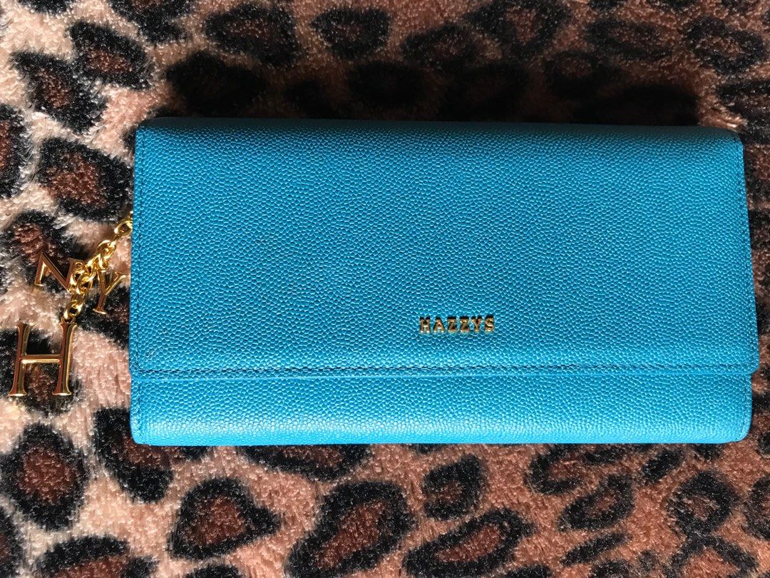 Hazzys Long Trifold Wallet (Category: Luxury Bags & Wallets) located in Santa Rosa. Submitted by rina.rina3 (Listing ID 1313998492, Image 1). Description: Very cute Hazzys long trifold wallet Preowned from Korea With zippered coin compartment and letters HZY detachable gold charms 💛 With at least 12 card slots 6 open pockets and 1 ID/photo slot Excellent gold hardwares and very durable leather With slight flaw ‘tastas’ on one of the open pockets