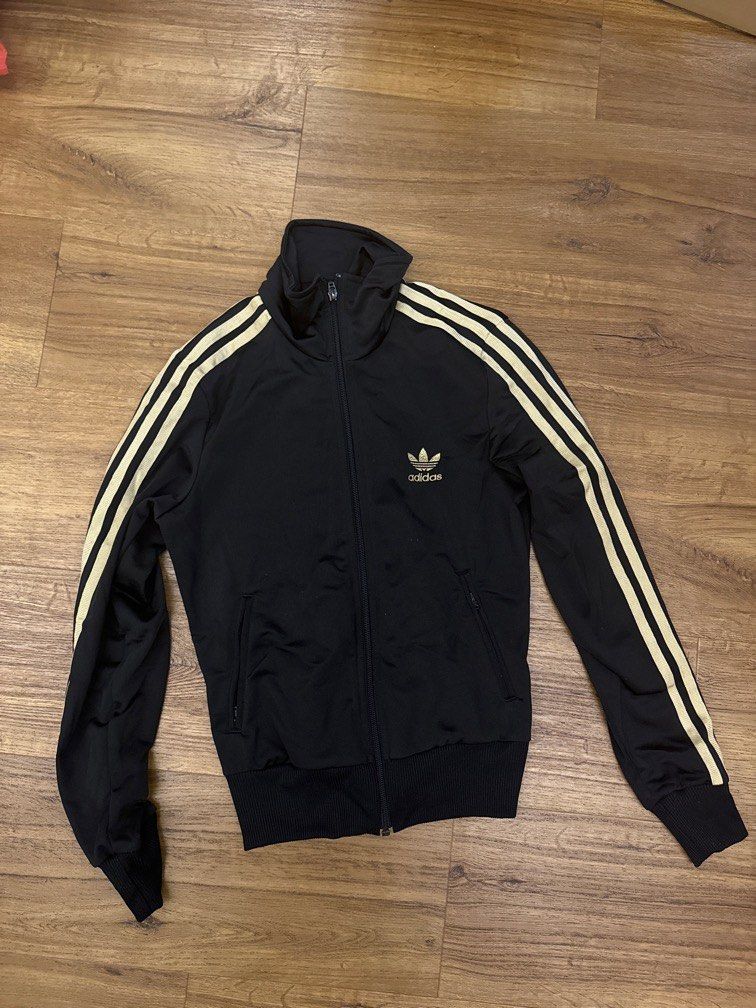 Black adidas jacket with gold stripes deals