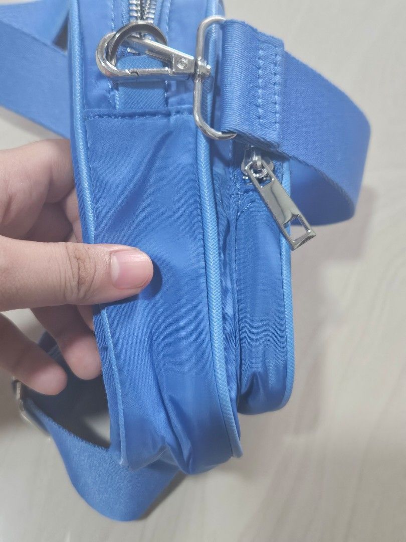 Blue nylon sling camera bag (Rubi / Cotton On) (Category: Cross-body Bags) located in Naga. Submitted by abbycatph (Listing ID 1314450843, Image 3). Description: -No issues or flaws -Still in brand new condition (used only once for a short event) -Bought from Rubi / Cotton on store online - Super cute and aesthetic! -Just right size to carry your essentials for going out on errands or activities.