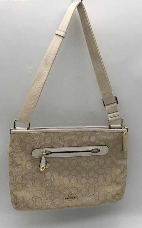 Coach Sling /Shoulder Cream Bag (Category: Cross-body Bags) located in Tacurong. Submitted by burbee05 (Listing ID 1314699606, Image 1). Description: ⭐️LIKE NEW ⭐️Authentic ♥️Coach 37587 Signature Taylor Crossbody Canvas Bag ➡️Medium ➡️Beautiful cream colored messenger bag. It has 1 inch adjustable strap and a front zipper pocket and a snap pocket on the other side. 2 cell phone pockets and one zipper pocket on the inside. It also zippers close..