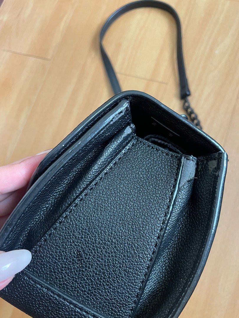 Charles & Keith Matte Black Push-Lock Crossbody Bag (Category: Cross-body Bags) located in Marilao. Submitted by aint_b23 (Listing ID 1314935803, Image 3). Description: Charles & Keith Matte Black Push-Lock Crossbody Bag flaws: leather rubs on the side, scratched hardware sling sf to be shouldered by the buyer.