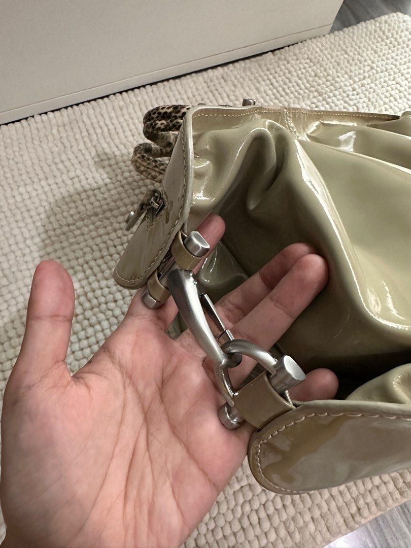 Calvin Klein Patent Leather convertible bag (Category: Luxury Bags & Wallets) located in Makati City. Submitted by miranda.dy (Listing ID 1315014198, Image 3). Description: Top handles are made for snakeskin. Has a smudge and discoloration. See pictures for details, the rest of the bag works fine. Very spacious. Can fit 14-16inch laptop inside when unbuckled. What you see is what you get. .