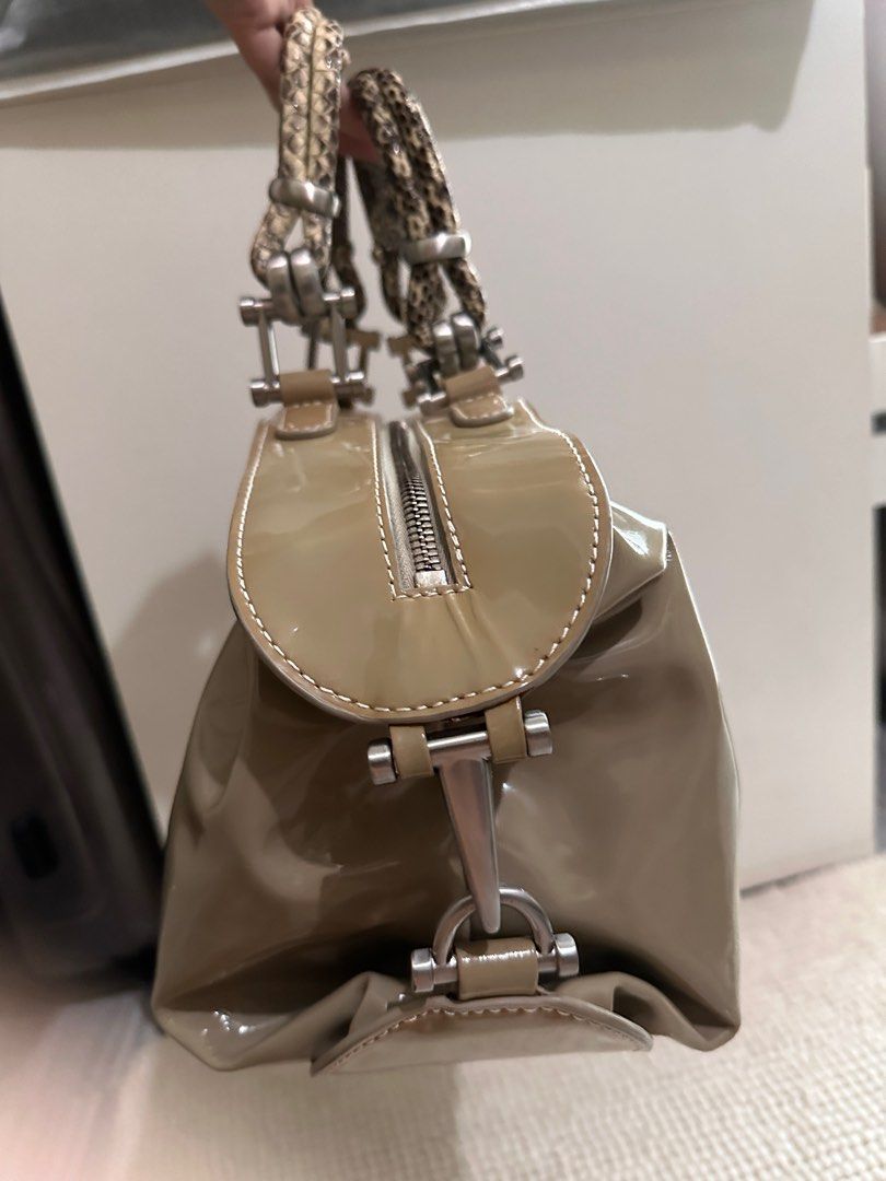 Calvin Klein Patent Leather convertible bag (Category: Luxury Bags & Wallets) located in Makati City. Submitted by miranda.dy (Listing ID 1315014198, Image 2). Description: Top handles are made for snakeskin. Has a smudge and discoloration. See pictures for details, the rest of the bag works fine. Very spacious. Can fit 14-16inch laptop inside when unbuckled. What you see is what you get. .