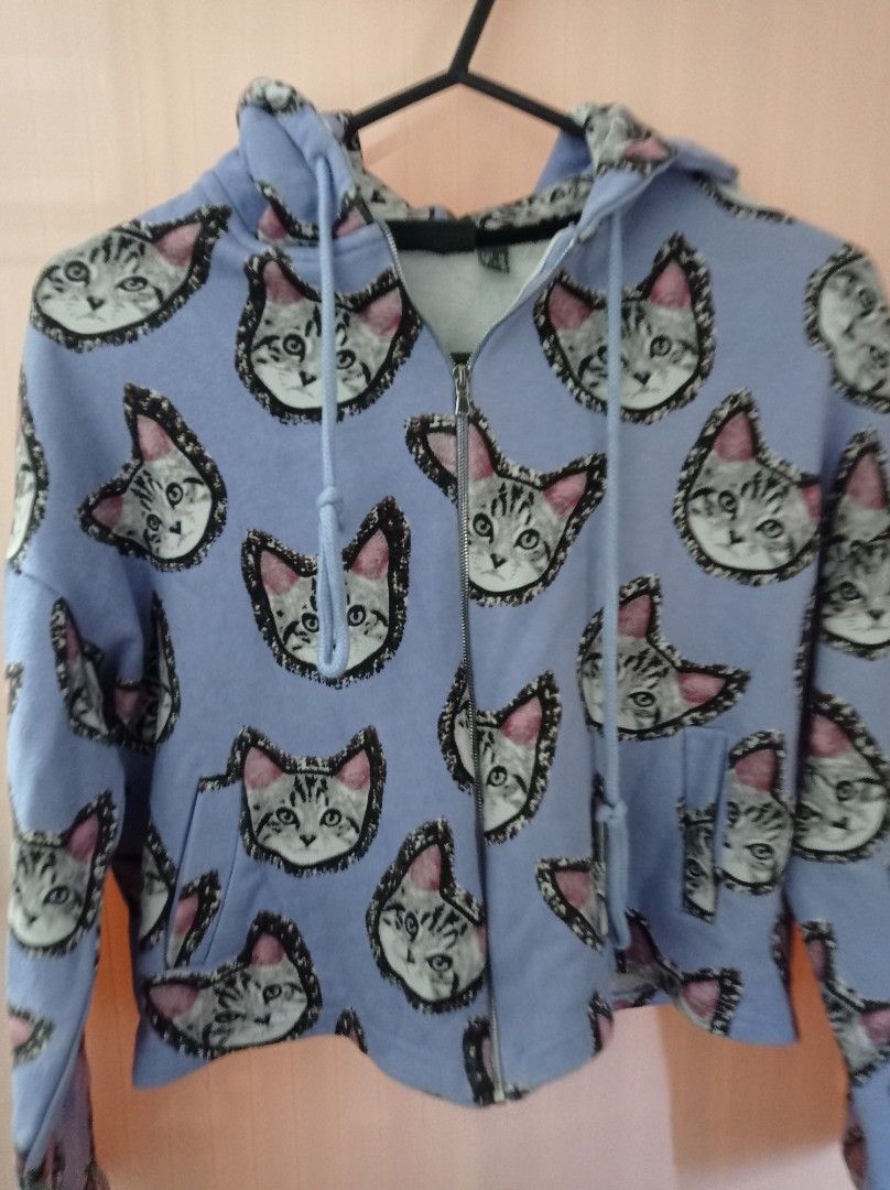 Blue Cat Design Crop Top Jacket/Hoodie (Category: Coats, Jackets and Outerwear) located in Tanza. Submitted by gratefuljam05 (Listing ID 1315229352, Image 2). Description: Blue Cat Design Crop Top Jacket/Hoodie fits small to medium body frame Length: 43cm Shoulder: 63cm Sleeves: 43cm Armpit: 32cm Bust: 98cm Waist: 40in w/minimal stains as seen on the picture.