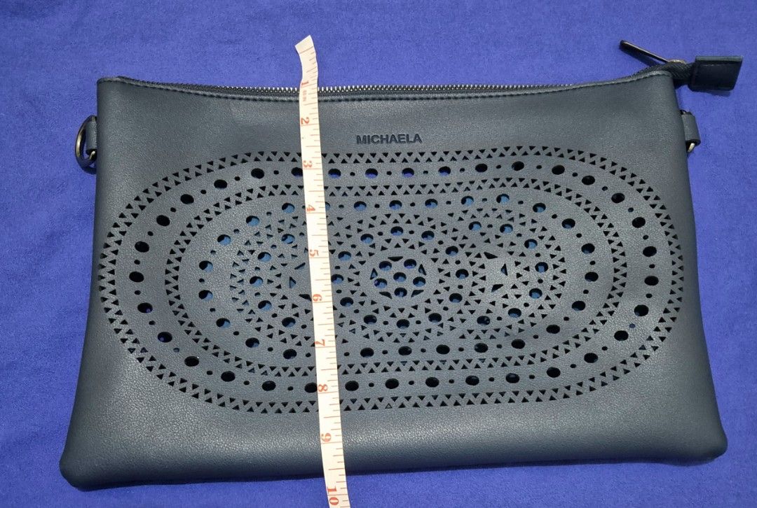 MIchaela Sling Bag (Category: Cross-body Bags) located in Pasig City. Submitted by zduran04 (Listing ID 1315262287, Image 3). Description: -Original Michaela Bag - Blue sling bag with long and short strap included -never used -measurement is in the picture -can be sling bag or pouch bag.