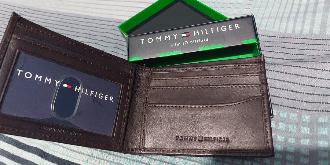 Authentic Tommy Hilfiger Wallet NEW IN BOX (Category: Wallets & Card Holders) located in Manila. Submitted by time07 (Listing ID 1311977807, Image 2). Description: Tommy Hilfiger Men's Leather Wallet / Billfold --Security strap still attached. --Premium Leather Bi-fold Wallet --This is a brand new bi-fold wallet, spacious enough to hold all your cards and cash. --Great gift for men. Brand: Tommy Hilfiger Style: Billfold Color: Dark Brown Material