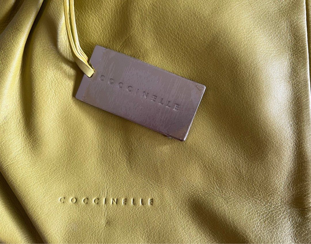 Coccinelle (Category: Tote Bags) located in Quezon City. Submitted by pingtbl (Listing ID 1311939458, Image 3). Description: Soft lamb skin material H 12” L 17” Fabric inner material Inner zip pocket & small open pocket Magnetic closure Never been used, just stored No damage on leather With light inner stains due to storage.