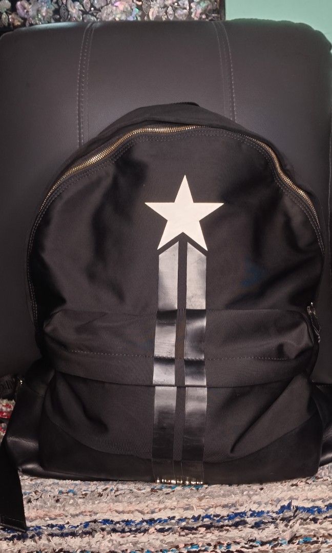 GIVENCHY star backpack (Category: Backpacks) located in Legazpi City. Submitted by georgepineda791 (Listing ID 1311913070, Image 1). Description: Durable Nylon Canvas. Features Givenchy underzip with code. Very minimal signs of usage on the pullers. Flaw to note: The front lower leather part shows deterioration/peeling due to age and long storage. This is already visible and should be considered before purchasing..