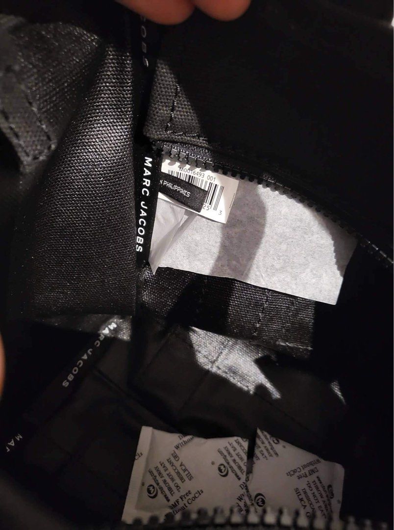 Marc Jacobs The Mini Tote Bag in Black (Category: Luxury Bags & Wallets) located in Quezon City. Submitted by cheskart (Listing ID 1312054660, Image 3). Description: Marc Jacobs The Mini Tote Bag in Black 💯 original, outlet item cotton canvas top zip closure top handle, removable and adjustable webbing strap Dimensions: 10in L x 5in D x 8in H 26cm L x 13cm D x 21cm H Strap 57in L x 2in D (144cm L x 4cm D) Strap Drop 27in (69cm) Handle Drop 4in (
