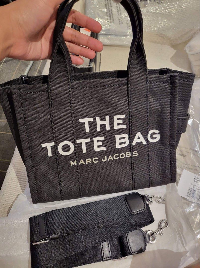 Marc Jacobs The Mini Tote Bag in Black (Category: Luxury Bags & Wallets) located in Quezon City. Submitted by cheskart (Listing ID 1312054660, Image 1). Description: Marc Jacobs The Mini Tote Bag in Black 💯 original, outlet item cotton canvas top zip closure top handle, removable and adjustable webbing strap Dimensions: 10in L x 5in D x 8in H 26cm L x 13cm D x 21cm H Strap 57in L x 2in D (144cm L x 4cm D) Strap Drop 27in (69cm) Handle Drop 4in (