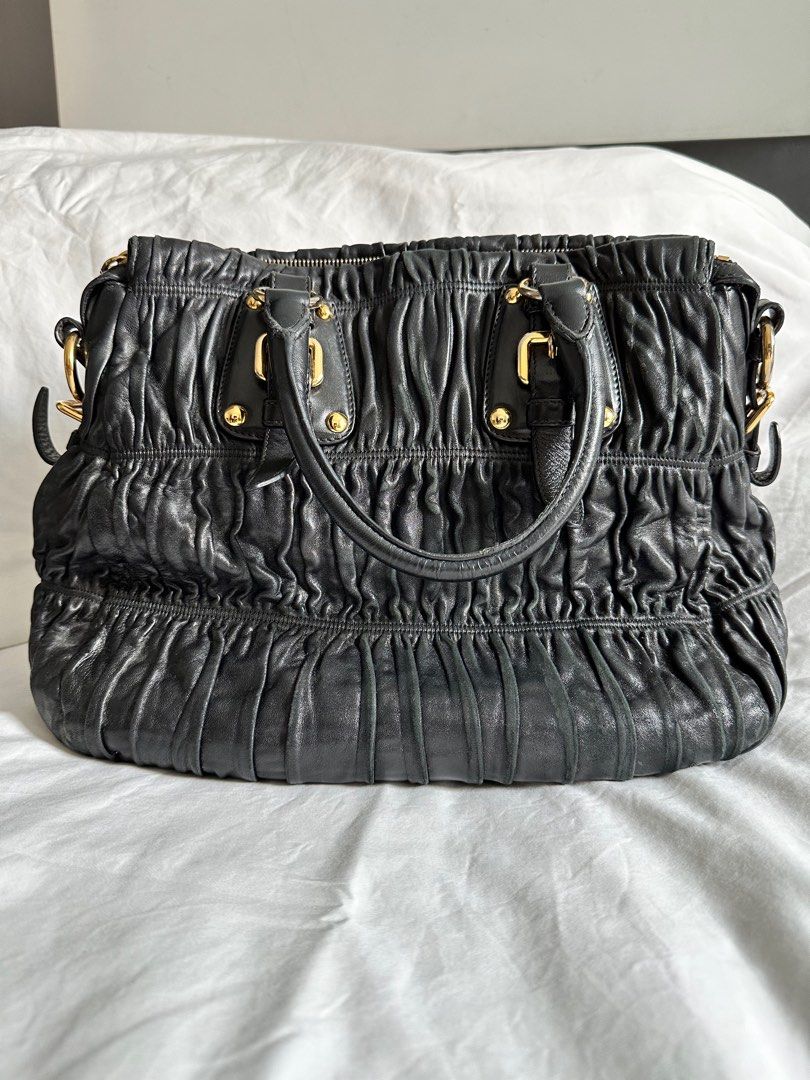 Prada Nappa Gaufre Leather Top Handle Bag - Medium (Category: Bags & Wallets) located in Singapore. Submitted by venus21gt (Listing ID 1315367115, Image 2). Description: Authentic Prada soft leather bag. Well used but well taken care of. No torn leather just the usual scuffing. Usual tarnishing of gold hardware. Interior in good condition too. No torn in inner fabric. Negotiable for sincere buyers. .