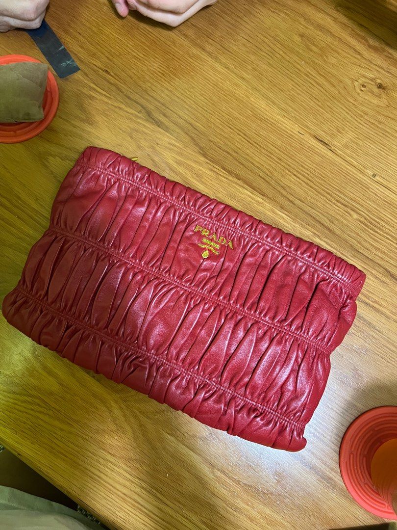 PRADA Red Nappa Gaufre Leather Clutch Bag (Category: Bags & Wallets) located in Singapore. Submitted by wilddaisy (Listing ID 1315435556, Image 1). Description: Only comes with authenticity card..