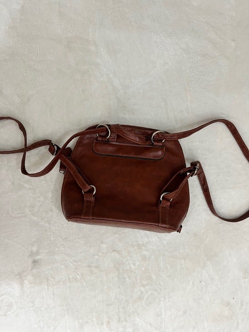 Brown Mini Backpack/Crossbody | 2in1 Bag (Category: Luxury Bags & Wallets) located in Quezon City. Submitted by fromfairydust (Listing ID 1315670876, Image 3). Description: Super nice pero I need to let this go kasi it’s so overused 😭 I use this almost everyday. • Genuine Leather ‼️ Medj may sira lang zippers kasi minsan di nasasara completely but this is easily repairable. Most times the zippers work naman..