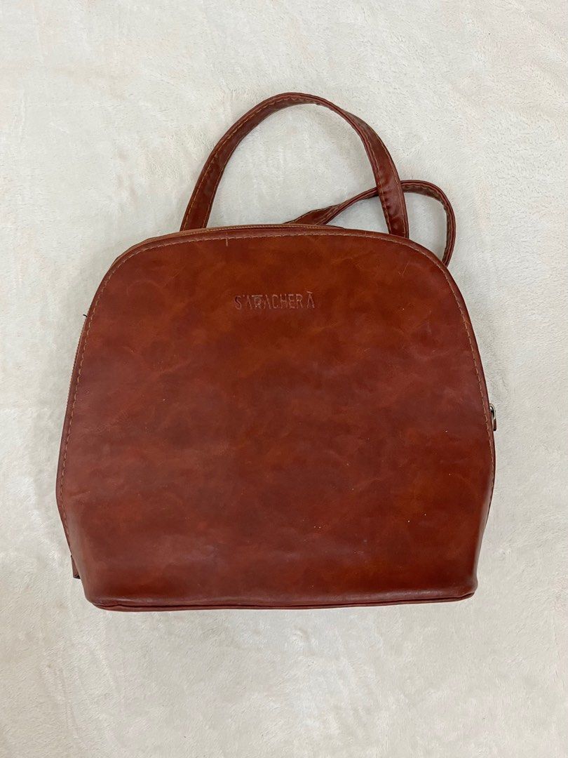 Brown Mini Backpack/Crossbody | 2in1 Bag (Category: Luxury Bags & Wallets) located in Quezon City. Submitted by fromfairydust (Listing ID 1315670876, Image 1). Description: Super nice pero I need to let this go kasi it’s so overused 😭 I use this almost everyday. • Genuine Leather ‼️ Medj may sira lang zippers kasi minsan di nasasara completely but this is easily repairable. Most times the zippers work naman..