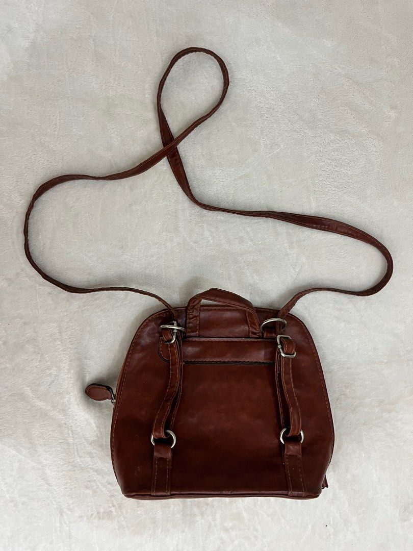 Brown Mini Backpack/Crossbody | 2in1 Bag (Category: Luxury Bags & Wallets) located in Quezon City. Submitted by fromfairydust (Listing ID 1315670876, Image 2). Description: Super nice pero I need to let this go kasi it’s so overused 😭 I use this almost everyday. • Genuine Leather ‼️ Medj may sira lang zippers kasi minsan di nasasara completely but this is easily repairable. Most times the zippers work naman..