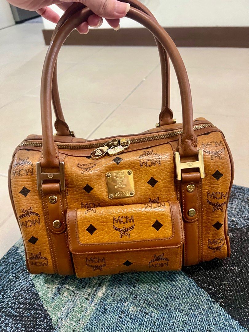 ORIGINAL MCM boston bag (Category: Luxury Bags & Wallets) located in Pasig City. Submitted by summerboutique07 (Listing ID 1315568852, Image 1). Description: ORIGINAL MCM MADE IN KOREA ✔️ YKK ZIPPER ✔️TURNABLE SCREW ✔️WITH TAG MADE IN KOREA *please see last photo for the minor flaw in the edge of the bottom part of the bag.