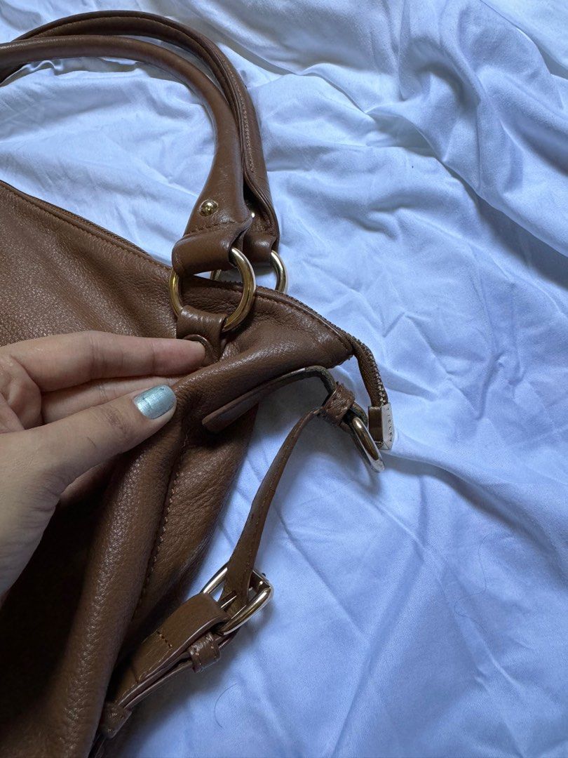 Sisley Genuine Leather Brown Two Way Bag (Category: Cross-body Bags) located in Davao. Submitted by stellietas (Listing ID 1316248162, Image 3). Description: Selling it low due to flaws. With small cracks and flaws on the linning or edges of the leather. But still good to use. Please see posted photos for details. Clean interior. With detachable sling strap..