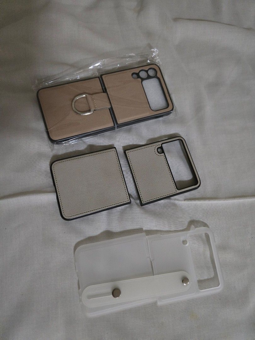TAKE ALL 3: Galaxy Flip3 generic cases (Category: Cases & Sleeves) located in Mandaluyong City. Submitted by teambc (Listing ID 1316159485, Image 1). Description: Galaxy Flip3 phone cases take all 3 for P250 - beige leather case with ring - nude leather case - matte clear strap case.