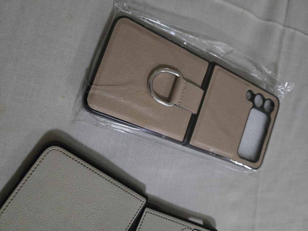 TAKE ALL 3: Galaxy Flip3 generic cases (Category: Cases & Sleeves) located in Mandaluyong City. Submitted by teambc (Listing ID 1316159485, Image 3). Description: Galaxy Flip3 phone cases take all 3 for P250 - beige leather case with ring - nude leather case - matte clear strap case.