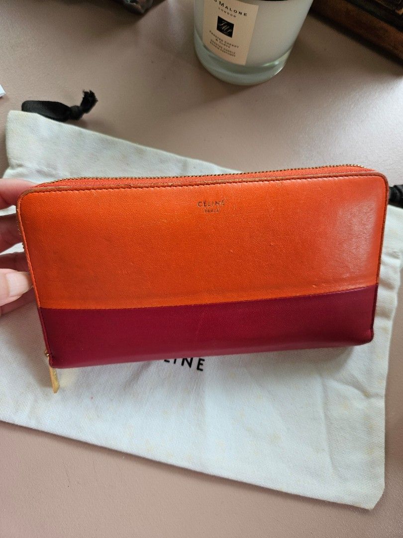 Céline zipped mulitfunction wallet (Category: Luxury Bags & Wallets) located in Manila. Submitted by cneshop (Listing ID 1316304884, Image 1). Description: •CÉLINE zipped multifunction wallet •orange and magenta color w/ gold hardware •complete with dust bag and cards.